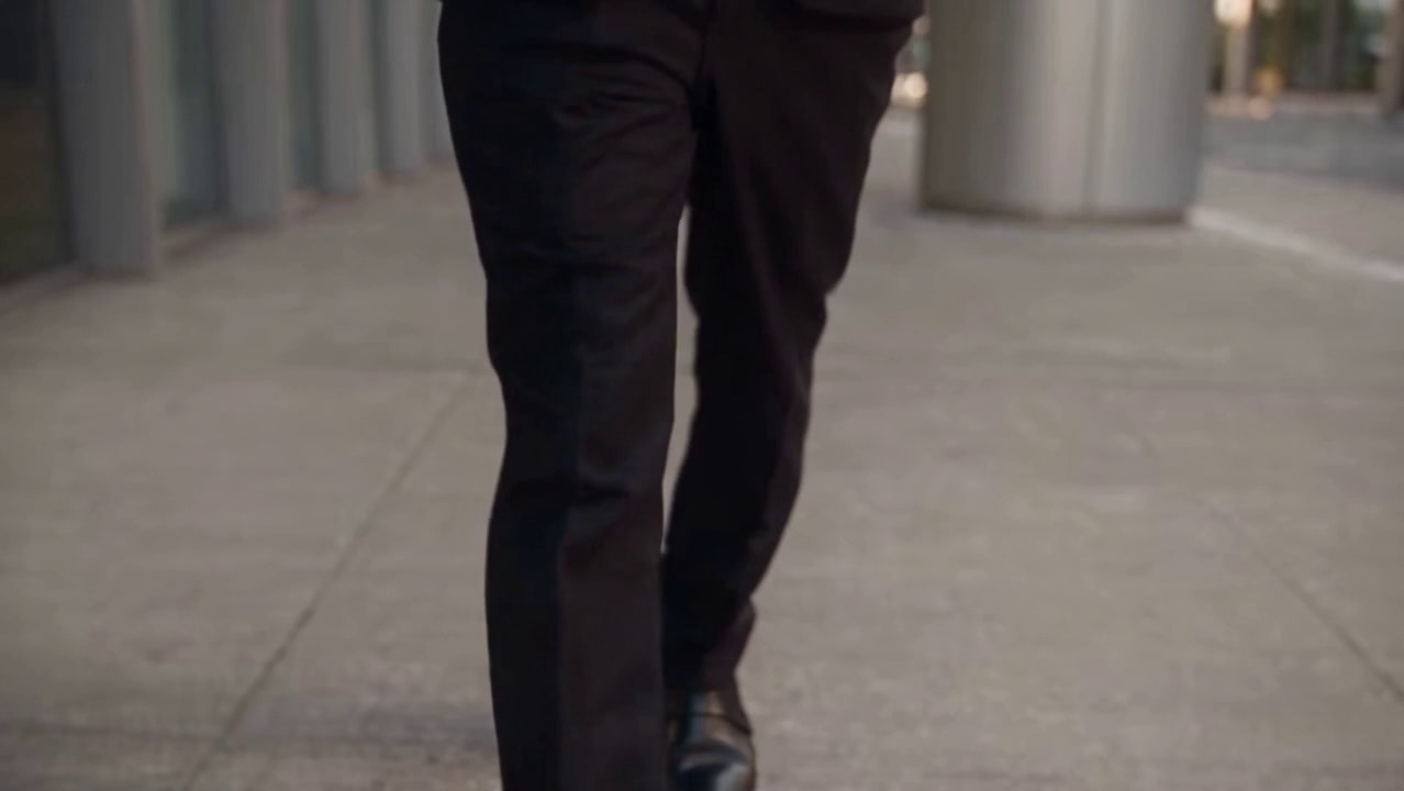 Frame from a Sloosh Add a Soundtrack template: a businessman spilling chai on a city sidewalk