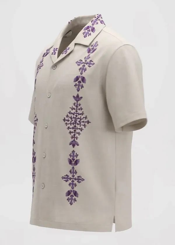 Generated input at 1.00 s: light shirt with purple embroidery